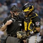 Pittsburgh Pirates catcher Elias Diaz checks on home plate umpire Lance Barksdale after Barksdale was hit by a pitch during the second inning of the team's baseball game against the Arizona Diamondbacks, Tuesday, May 14, 2019, in Phoenix. (AP Photo/Matt York)