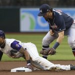 Arizona Diamondbacks' Jarrod Dyson, left, steals second base as Atlanta Braves shortstop Dansby Swanson, right, applies a late tag during the first inning of a baseball game Thursday, May 9, 2019, in Phoenix. (AP Photo/Ross D. Franklin)