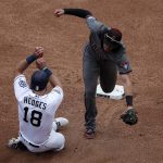 Arizona Diamondbacks shortstop Nick Ahmed, right, fields a sacrifice bunt by San Diego Padres' Eric Lauer as Padres' Austin Hedges (18) arrives safely to second base during the third inning of a baseball game Wednesday, May 22, 2019, in San Diego. Lauer was out at first.  (AP Photo/Gregory Bull)
