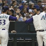 Arizona Diamondbacks' Christian Walker (53) celebrates his run scored against the Atlanta Braves with Carson Kelly, right, during the second inning of a baseball game Thursday, May 9, 2019, in Phoenix. (AP Photo/Ross D. Franklin)
