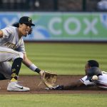 Pittsburgh Pirates shortstop Cole Tucker, left, waits for a late throw as Arizona Diamondbacks' Jarrod Dyson, right, steals second base during the first inning of a baseball game Monday, May 13, 2019, in Phoenix. (AP Photo/Ross D. Franklin)