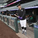 Colorado Rockies shortstop Trevor Story heads out to the batting cage to warm up before a baseball game against the Arizona Diamondbacks, Tuesday, May 28, 2019, in Denver. (AP Photo/David Zalubowski)