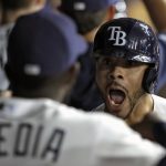 Tampa Bay Rays' Tommy Pham, right, celebrates in the dugout with Guillermo Heredia after hitting a grand slam off Arizona Diamondbacks starting pitcher Merrill Kelly during the second inning of a baseball game Monday, May 6, 2019, in St. Petersburg, Fla. (AP Photo/Chris O'Meara)