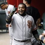 San Francisco Giants' Pablo Sandoval celebrates in the dugout after hitting a pinch-hit home run against the Arizona Diamondbacks during the 10th inning of a baseball game, Sunday, May 19, 2019, in Phoenix. (AP Photo/Ralph Freso)
