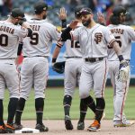 San Francisco Giants outfielder Kevin Pillar, right center, is congratulated by teammates Evan Longoria (10), Brandon Belt (9), Joe Panik (12) and Brandon Crawford, right, following their victory in 10 innings over the Arizona Diamondbacks in a baseball game, Sunday, May 19, 2019, in Phoenix. (AP Photo/Ralph Freso)