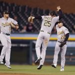 Oakland Athletics left fielder Chad Pinder (18), right fielder Stephen Piscotty (25), and center fielder Ramon Laureano (22) celebrate their win over the Detroit Tigers in a baseball game, Friday, May 17, 2019, in Detroit. (AP Photo/Carlos Osorio)