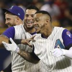 Arizona Diamondbacks' Ketel Marte, right, celebrates his walk-off single against the Atlanta Braves in the 10th inning with David Peralta, middle, and Merrill Kelly, left, in a baseball game Thursday, May 9, 2019, in Phoenix. The Diamondbacks won 3-2. (AP Photo/Ross D. Franklin)