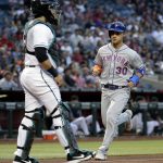 New York Mets' Michael Conforto (30) scores on a base hit by teammate Todd Frazier during the second inning of a baseball game as Arizona Diamondbacks catcher Alex Avila looks on, Friday, May 31, 2019, in Phoenix. (AP Photo/Matt York)