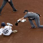 Arizona Diamondbacks shortstop Nick Ahmed, right, tags out San Diego Padres' Eric Hosmer, who was trying to reach second after a single during the fourth inning of a baseball game Wednesday, May 22, 2019, in San Diego. (AP Photo/Gregory Bull)
