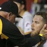 Pittsburgh Pirates pitching coach Ray Searage, left, talks with starting pitcher Nick Kingham, right, after Kingham gave up five runs to the Arizona Diamondbacks during the first two innings of a baseball game Monday, May 13, 2019, in Phoenix. (AP Photo/Ross D. Franklin)