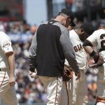 San Francisco Giants pitcher Andrew Suarez, left, walks off the mound after being relieved by manager Bruce Bochy, center, as third baseman Pablo Sandoval and catcher Buster Posey (28) wait during the fifth inning of a baseball game against the Arizona Diamondbacks in San Francisco, Saturday, May 25, 2019. (AP Photo/Jeff Chiu)