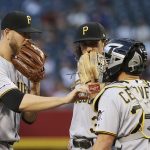 Pittsburgh Pirates starting pitcher Nick Kingham, left, talks with catcher Francisco Cervelli, right, and shortstop Cole Tucker, center, during the first inning of a baseball game against the Arizona Diamondbacks, Monday, May 13, 2019, in Phoenix. (AP Photo/Ross D. Franklin)