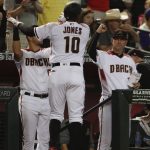 Arizona Diamondbacks' Adam Jones celebrates at the dugout after a home run against the Pittsburgh Pirates during the fifth inning of a baseball game in Phoenix, Wednesday, May 15, 2019. (AP Photo/Matt York)