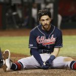 Atlanta Braves' Dansby Swanson sits on the ground after fouling off a pitch that nearly hit him during the seventh inning of the team's baseball game against the Arizona Diamondbacks on Thursday, May 9, 2019, in Phoenix. (AP Photo/Ross D. Franklin)