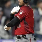 Arizona Diamondbacks' Adam Jones gestures as he crosses home plate after hitting a solo home run off Colorado Rockies starting pitcher Jeff Hoffman in the fifth inning of a baseball game Wednesday, May 29, 2019, in Denver. (AP Photo/David Zalubowski)