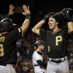 Pittsburgh Pirates' Cole Tucker celebrates his two-run home run with Melky Cabrera (53) during the eighth inning of the team's baseball game against the Arizona Diamondbacks, Tuesday, May 14, 2019, in Phoenix. (AP Photo/Matt York)