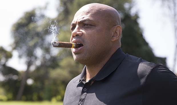 NBA Hall of Famer Charles Barkley looks on while smoking a cigar during the Julius Erving Golf Clas...