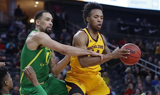 Arizona State's Kimani Lawrence, right, grabs a rebound over Oregon's Paul White during the first h...