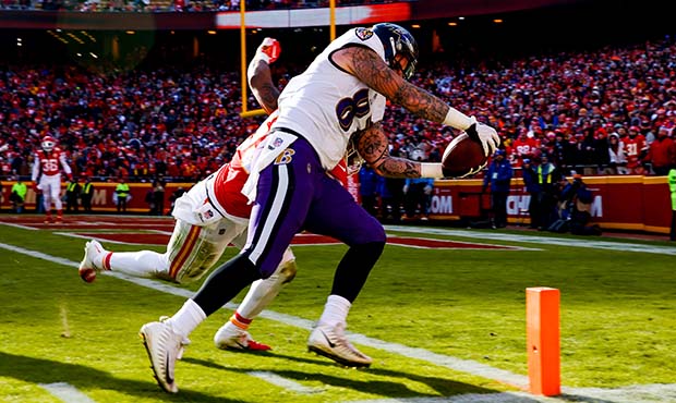 Maxx Williams #87 of the Baltimore Ravens crosses the goal line through the tackle attempt of Antho...