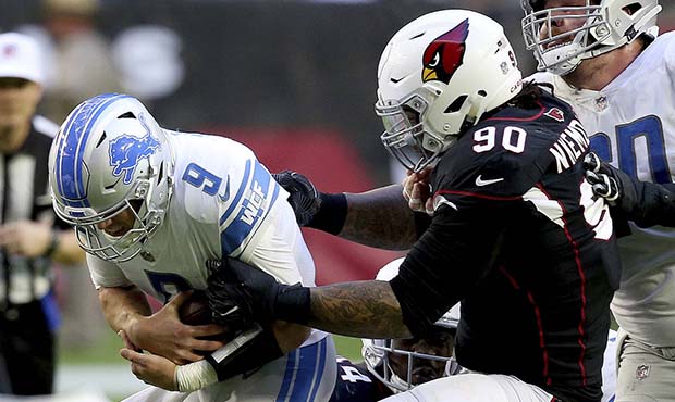Detroit Lions quarterback Matthew Stafford (9) is hit by Arizona Cardinals defensive tackle Robert ...