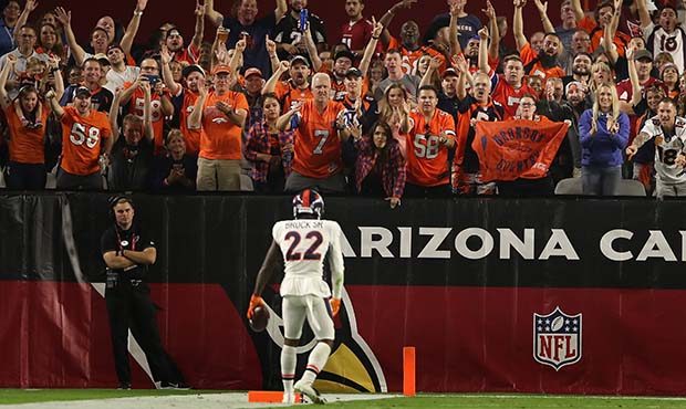Fans of the Denver Broncos cheer after defensive back Tramaine Brock #22 picked up a loose ball dur...