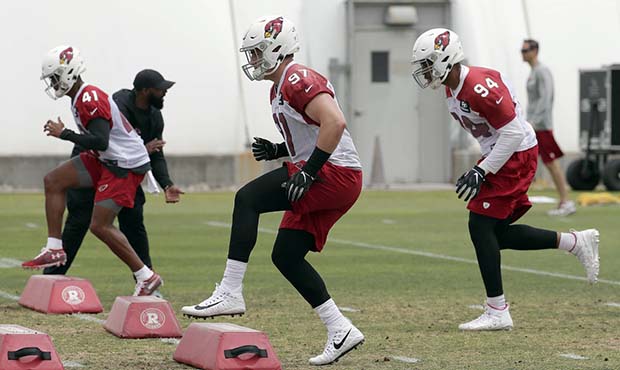 Arizona Cardinals' Zach Allen (97), Nate Brooks (41) and Cameron Malveaux (94) work out during an N...