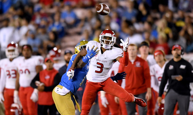 KeeSean Johnson #3 of the Fresno State Bulldogs makes a catch in front of Darnay Holmes #1 of the U...