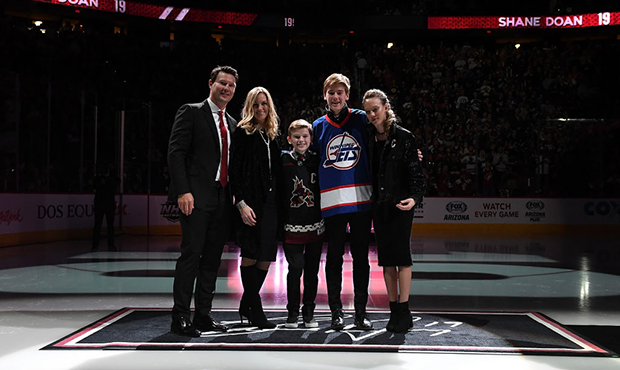 Shane Doan, wife Andrea and kids Josh, Carson and Karys pose for a photo as a 'Doan 19' banner is r...
