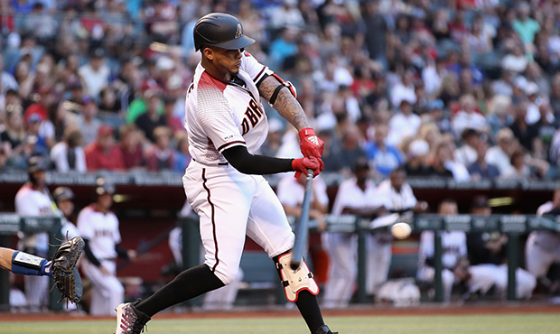 Ketel Marte #4 of the Arizona Diamondbacks hits a single against the Los Angeles Dodgers during the...