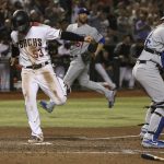 Arizona Diamondbacks' Christian Walker (53) scores a run as Los Angeles Dodgers catcher Will Smith, right, and Dodgers relief pitcher Dylan Floro, middle, wait for a possible throw to home plate during the eighth inning of a baseball game, Monday, June 24, 2019, in Phoenix. (AP Photo/Ross D. Franklin)