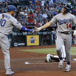 Los Angeles Dodgers' Enrique Hernandez (14) celebrates his home run against the Arizona Diamondbacks with Dodgers' Justin Turner (10) during the first inning of a baseball game, Tuesday, June 25, 2019, in Phoenix. (AP Photo/Ross D. Franklin)