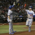 Los Angeles Dodgers' Alex Verdugo (27) celebrates his run scored against the Arizona Diamondbacks with teammate Will Smith during the sixth inning of a baseball game, Tuesday, June 25, 2019, in Phoenix. (AP Photo/Ross D. Franklin)
