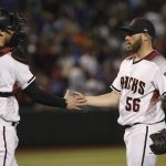 Arizona Diamondbacks relief pitcher Greg Holland (56) slaps hands with Diamondbacks catcher Carson Kelly, left, after the final out of the ninth inning of a baseball game against the Los Angeles Dodgers, Monday, June 24, 2019, in Phoenix. The Diamondbacks' Holland earned his 200th career save, and the Diamondbacks defeated the Dodgers 8-4. (AP Photo/Ross D. Franklin)