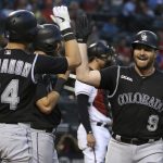 Colorado Rockies' Daniel Murphy (9) celebrates his two-run home run against the Arizona Diamondbacks with Rockies' Ryan McMahon (24) and David Dahl, back left, during the fourth inning of a baseball game Wednesday, June 19, 2019, in Phoenix. (AP Photo/Ross D. Franklin)