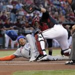 New York Mets' Dominic Smith scores under the tag of Arizona Diamondbacks catcher Alex Avila, right, on a double by Pete Alonso during the first inning of a baseball game, Saturday, June 1, 2019, in Phoenix. (AP Photo/Matt York)