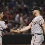 San Francisco Giants relief pitcher Will Smith, right, shakes hands with catcher Buster Posey after the final out of a baseball game against the Arizona Diamondbacks on Saturday, June 22, 2019, in Phoenix. The Giants defeated the Diamondbacks 7-4. (AP Photo/Ross D. Franklin)