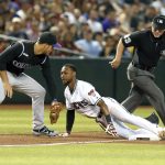 Arizona Diamondbacks' Jarrod Dyson dives safely into third base under the tag of Colorado Rockies third baseman Nolan Arenado, left, on a single hit by Ketel Marte in the fifth inning during a baseball game, Tuesday, June 18, 2019, in Phoenix. (AP Photo/Rick Scuteri)