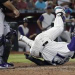 Arizona Diamondbacks' Nick Ahmed falls after being hit by a pitch during the third inning of a baseball game against the Colorado Rockies, Thursday, June 20, 2019, in Phoenix. (AP Photo/Matt York)