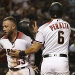 Arizona Diamondbacks' Christian Walker (53) and David Peralta (6) celebrate their runs scored against the Los Angeles Dodgers during the eighth inning of a baseball game, Monday, June 24, 2019, in Phoenix. (AP Photo/Ross D. Franklin)