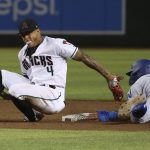 Arizona Diamondbacks second baseman Ketel Marte (4) tries a back-handed tag as Los Angeles Dodgers' Chris Taylor (3) slides safely into second with a stolen base during the eighth inning of a baseball game Tuesday, June 25, 2019, in Phoenix. (AP Photo/Ross D. Franklin)