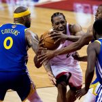 Toronto Raptors forward Kawhi Leonard (2) draws a foul as he drives to the net against Golden State Warriors center DeMarcus Cousins (0), forward Draymond Green (23) and forward Andre Iguodala (9) during second-half basketball action in Game 5 of the NBA Finals in Toronto, Monday, June 10, 2019. (Chris Young/The Canadian Press via AP)