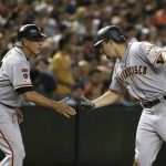 San Francisco Giants' Alex Dickerson, right, celebrates his two-run triple against the Arizona Diamondbacks with third base coach Ron Wotus during the seventh inning of a baseball game Friday, June 21, 2019, in Phoenix. (AP Photo/Ross D. Franklin)