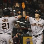 San Francisco Giants' Mike Yastrzemski, right, celebrates his two-run home run against the Arizona Diamondbacks with Stephen Vogt (21) during the ninth inning of a baseball game Saturday, June 22, 2019, in Phoenix. The Giants defeated the Diamondbacks 7-4. (AP Photo/Ross D. Franklin)