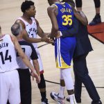 Golden State Warriors forward Kevin Durant (35) leaves after being injured as Toronto Raptors guard Kyle Lowry (7) talks to him during first-half basketball action in Game 5 of the NBA Finals in Toronto, Monday, June 10, 2019. (Nathan Denette/The Canadian Press via AP)