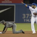 Toronto Blue Jays' Vladimir Guerrero Jr. gestures to dugout for a review of play at second base with Arizona Diamondbacks Jarrod Dyson stealing in the seventh inning of a baseball game Friday, June 7, 2019, in Toronto. The play was reviewed, and Dyson was ruled safe. (Fred Thornhill/The Canadian Press via AP)