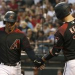 Arizona Diamondbacks' Eduardo Escobar, left, is congratulated by Carson Kelly after scoring against the San Francisco Giants during the first inning of a baseball game Saturday, June 22, 2019, in Phoenix. (AP Photo/Ross D. Franklin)