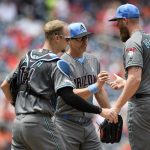 Arizona Diamondbacks starting pitcher Archie Bradley (25) is pulled from a baseball game by manager Torey Lovullo, center, during the second inning against the Washington Nationals, Sunday, June 16, 2019, in Washington. Diamondbacks catcher Caleb Joseph, left, looks on. (AP Photo/Nick Wass)