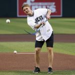 Arizona Coyotes NHL hockey team first round draft choice, Victor Soderstrom, of Sweden, wrist-shots the first pitch prior to a baseball game between the Arizona Diamondbacks and the Los Angeles Dodgers, Tuesday, June 25, 2019, in Phoenix. (AP Photo/Ross D. Franklin)