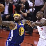 Golden State Warriors center DeMarcus Cousins (0) grabs a rebound in front of Toronto Raptors center Serge Ibaka (9) during second-half basketball action in Game 5 of the NBA Finals in Toronto, Monday, June 10, 2019. (Frank Gunn/The Canadian Press via AP)