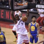 Toronto Raptors center Serge Ibaka (9) dunks as Golden State Warriors forward Jordan Bell (2), Quinn Cook (4) and Klay Thompson look on during second-half basketball action in Game 5 of the NBA Finals in Toronto, Monday, June 10, 2019. (Frank Gunn/The Canadian Press via AP)